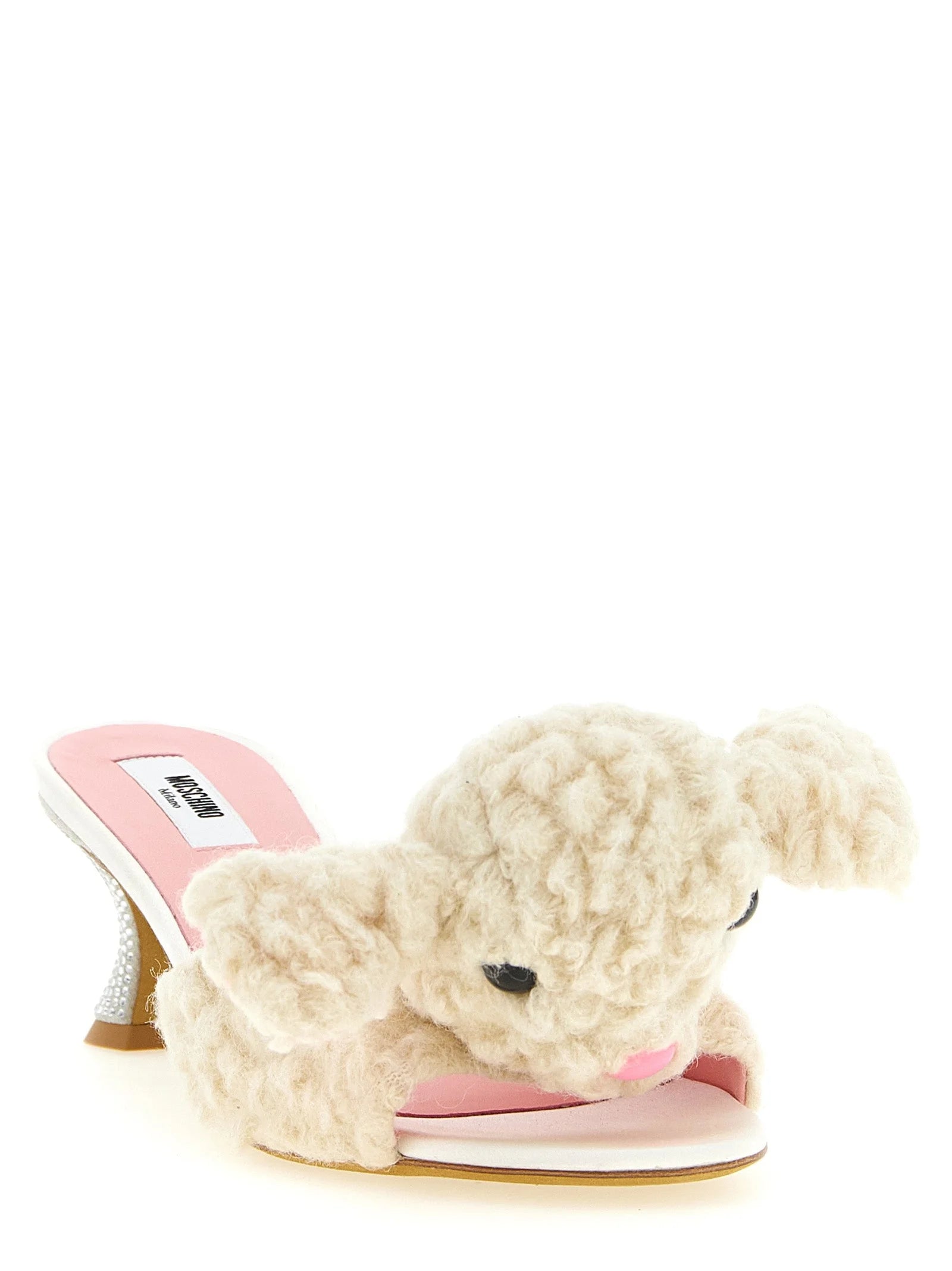 Side profile of Moschino wool mules in cream white, showcasing the flat sole and refined slip-on design.