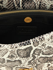 Close-up of the PINKO crossbody bag interior and iconic gold-tone bird ornament on the front flap.