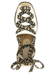 Close-up of the Stella McCartney wedge sandals revealing the tactile cotton fabric and premium craftsmanship.