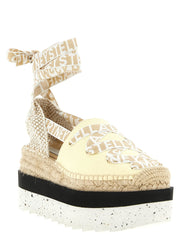 Side profile of Stella McCartney wedge sandals showcasing the architectural curve of the white polyethylene platform.
