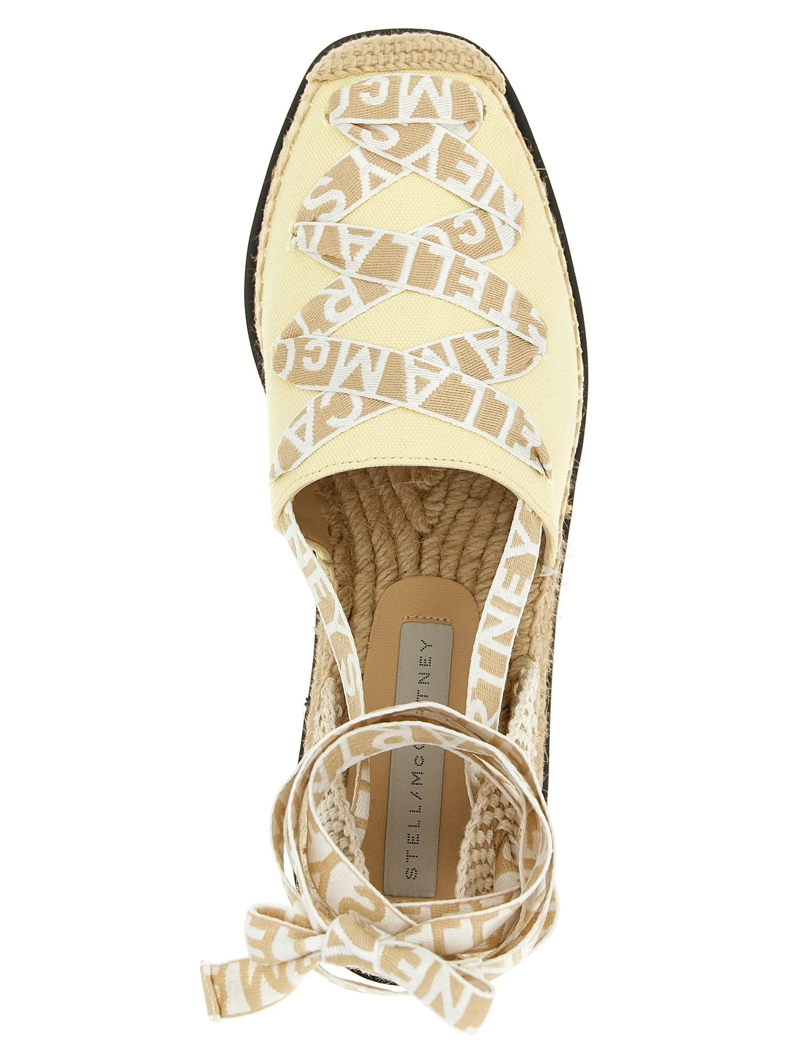 Close-up detail of the smooth polyethylene texture and refined finish on the Stella McCartney luxury wedge sandals.