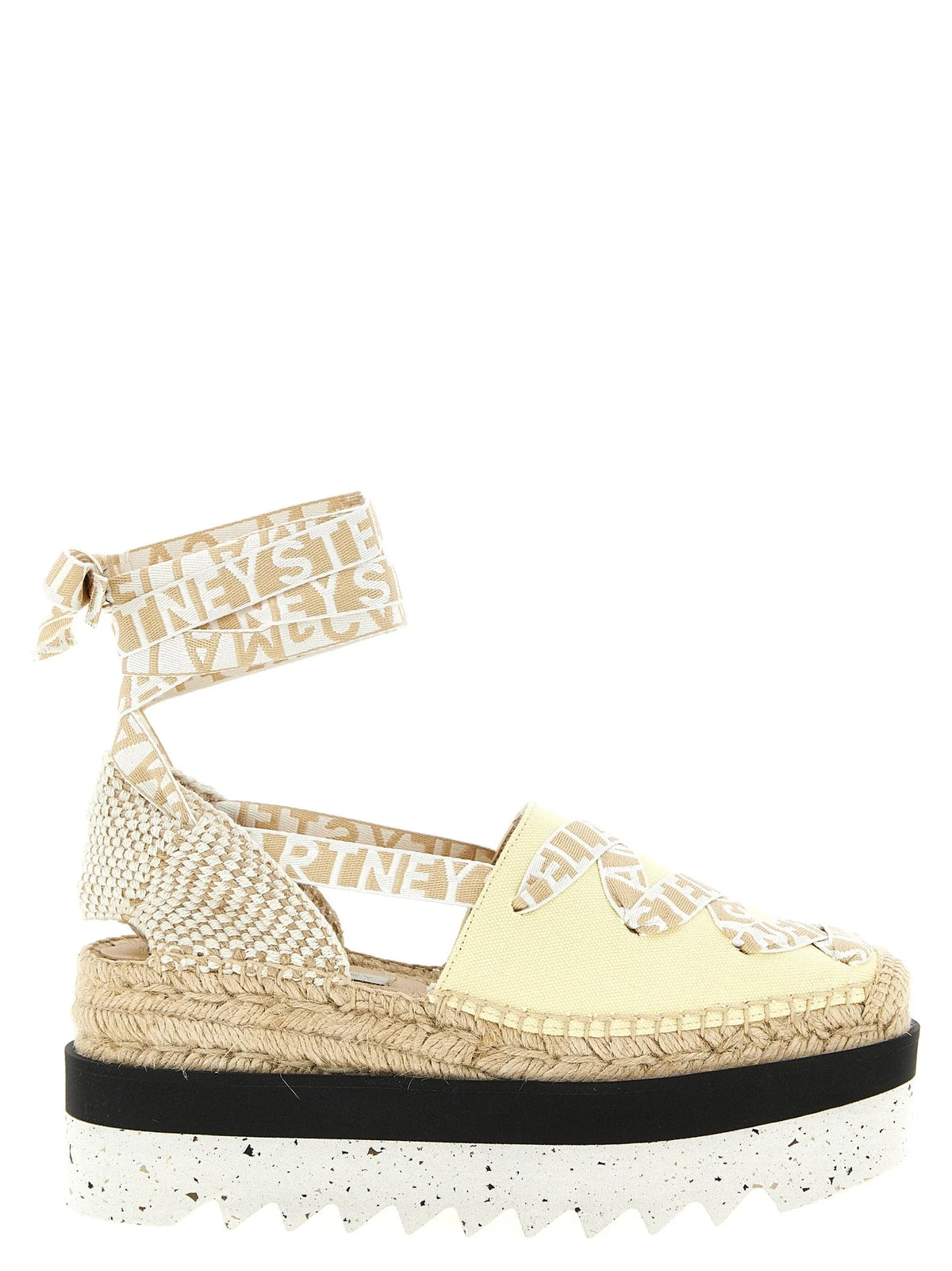 Stella McCartney bicolor polyethylene wedge sandals featuring a minimalist black strap and sculptural white platform base.