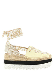 Stella McCartney bicolor polyethylene wedge sandals featuring a minimalist black strap and sculptural white platform base.