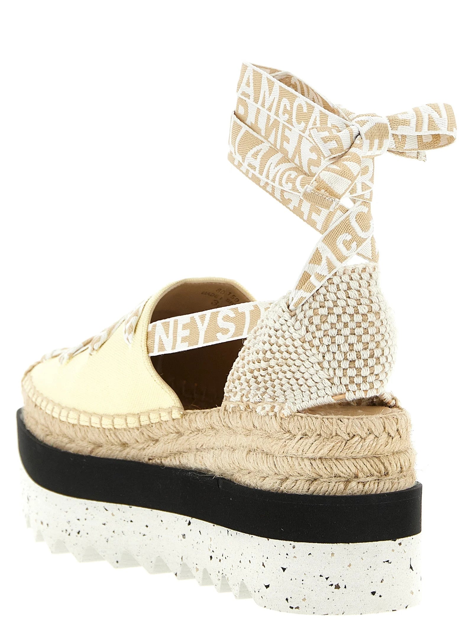 Rear view of the Stella McCartney bicolor sandals highlighting the clean lines and height of the modern wedge heel.