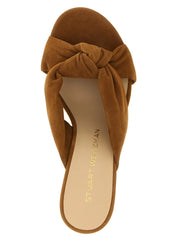 Close-up detail of the Stuart Weitzman brown polyethylene material and cushioned footbed with subtle brand logo.