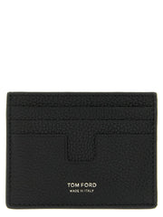 Framifrån vy av en Tom Ford svart kalvskinnskortplånbok med guldtonad logotypsprägling och flera kortfack.