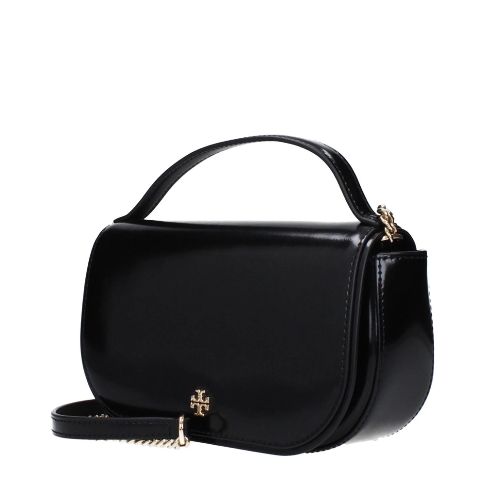 Side profile of the Tory Burch black leather bag highlighting its slim gusset design and refined edge stitching.