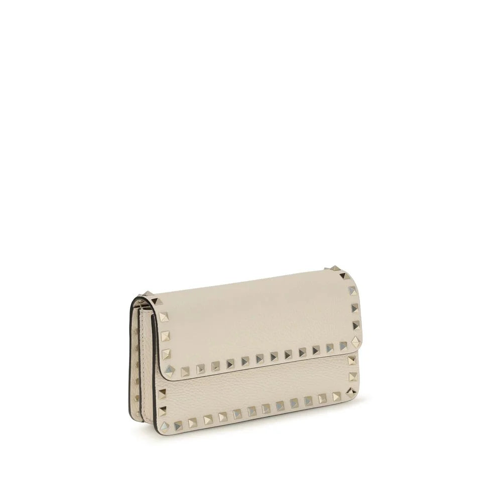 Side profile of the Valentino Garavani leather wallet in beige, showcasing the slim design and refined edge stitching.