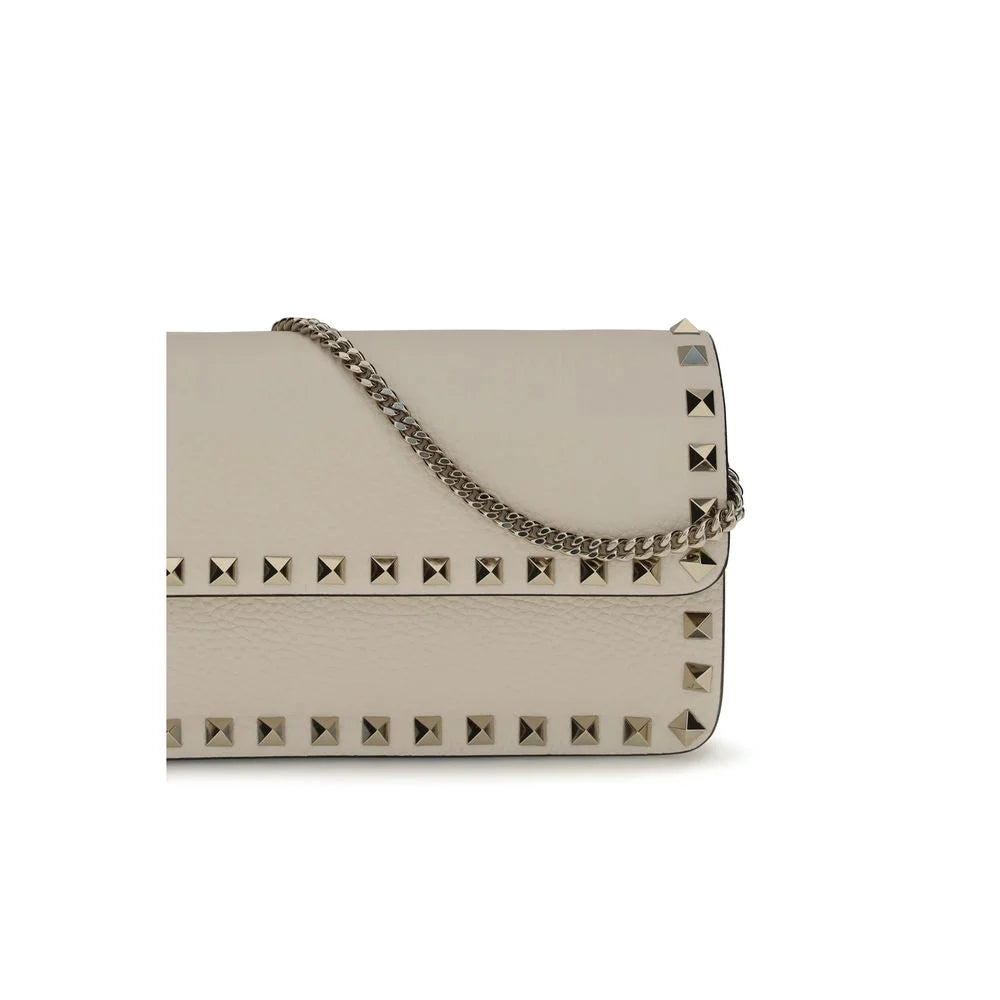 Close-up of the Valentino Garavani wallet interior, revealing organized card slots and premium calf leather texture.