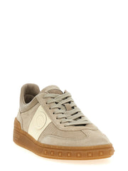 Side profile of Valentino Garavani luxury leather sneakers in beige, showcasing the clean silhouette and durable sole.