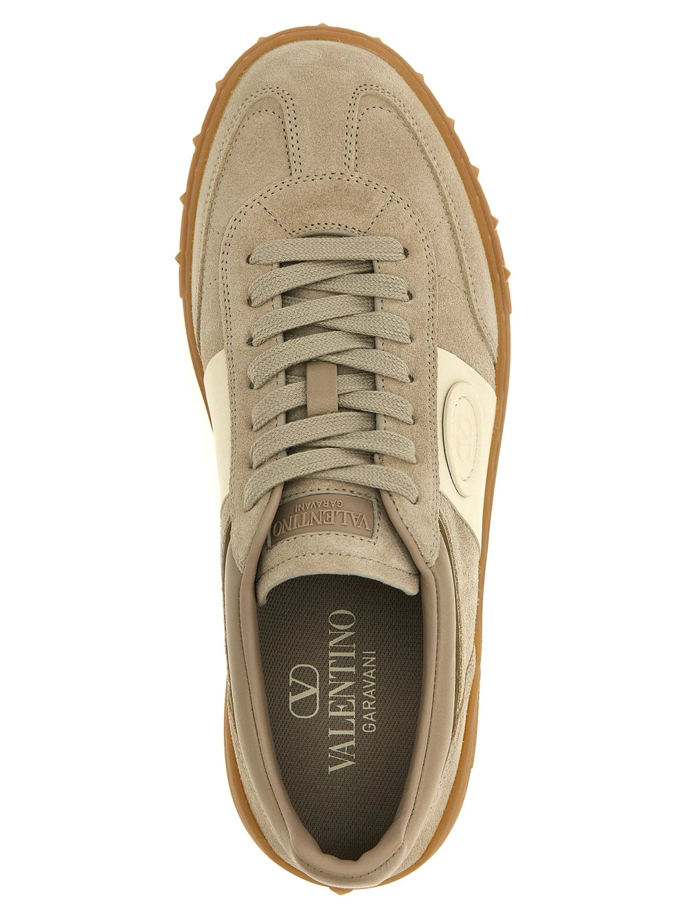 Close-up of the premium beige calfskin leather texture and tonal eyelets on these Valentino Garavani designer sneakers.