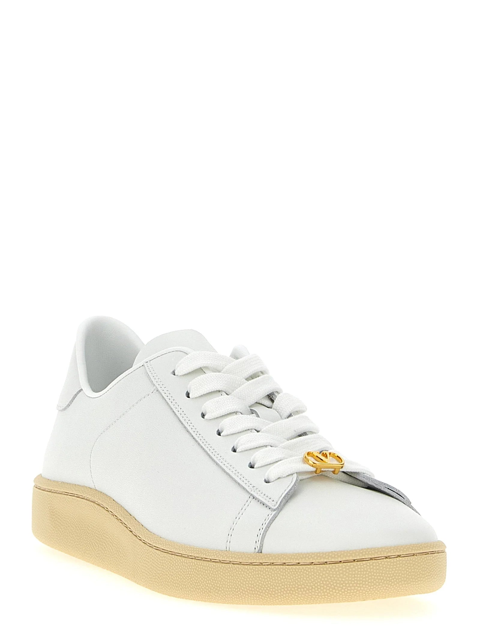 Side profile of Valentino Garavani white leather sneakers showcasing the clean architectural lines and rubber sole.