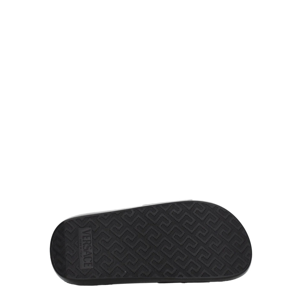 Vista superior de las chanclas de cuero de Versace que muestran la plantilla ergonómica y la elegante construcción abierta en el dedo del pie.