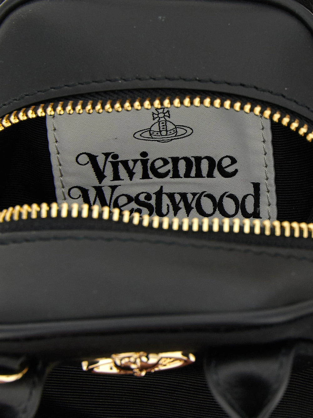 Närbild av Vivienne Westwoods handväska som visar den intricata texturen i svart viskos och silverbeslag.